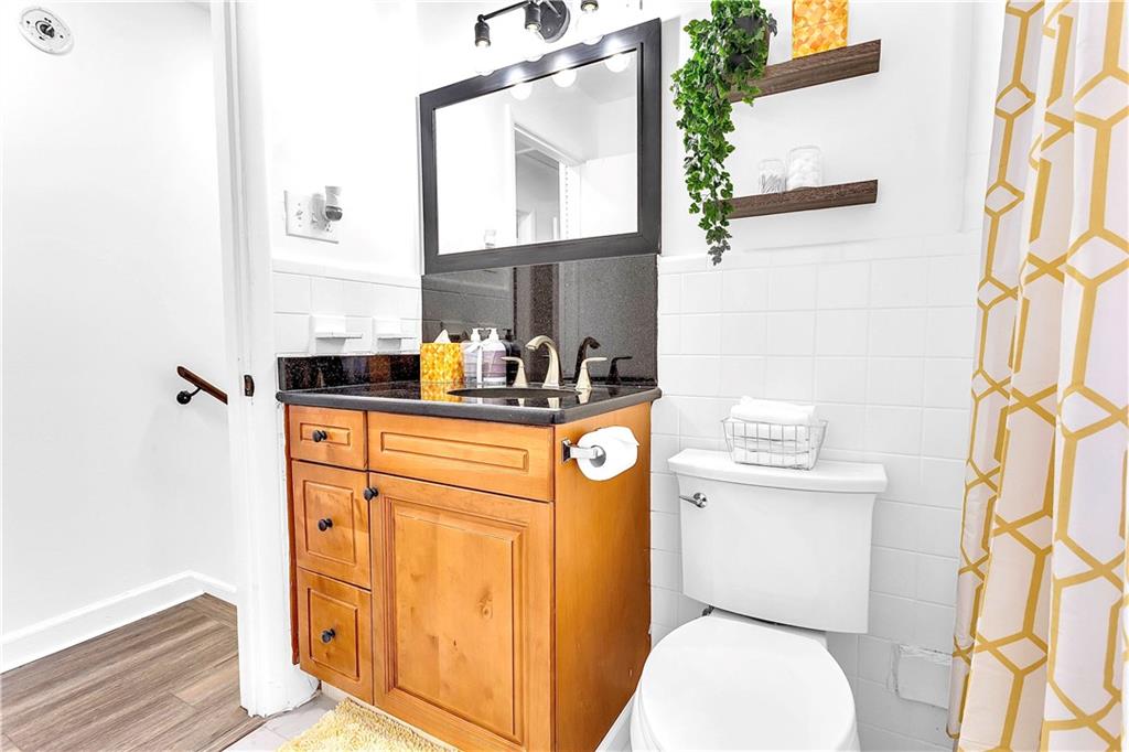 3571 Turner Heights Drive Decatur, GA 30032 - Photo 39 of 51 a bathroom with a sink a toilet and a mirror