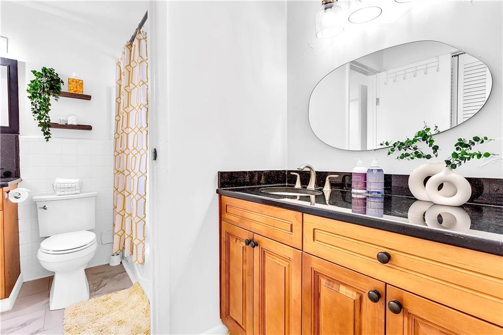 3571 Turner Heights Drive Decatur, GA 30032 - Photo 41 of 51 a bathroom with a granite countertop sink mirror vanity and toilet