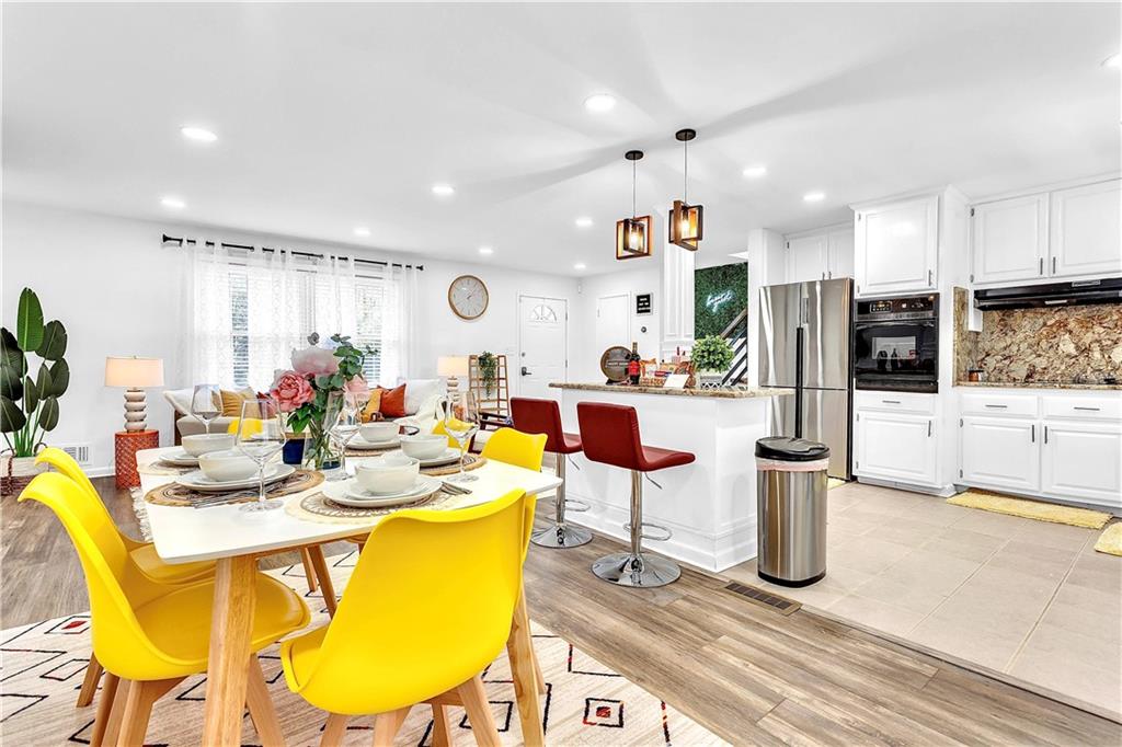3571 Turner Heights Drive Decatur, GA 30032 - Photo 6 of 51 a kitchen with stainless steel appliances kitchen island granite countertop a table and chairs in it