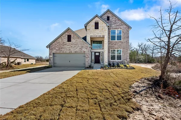 a front view of a house with a yard