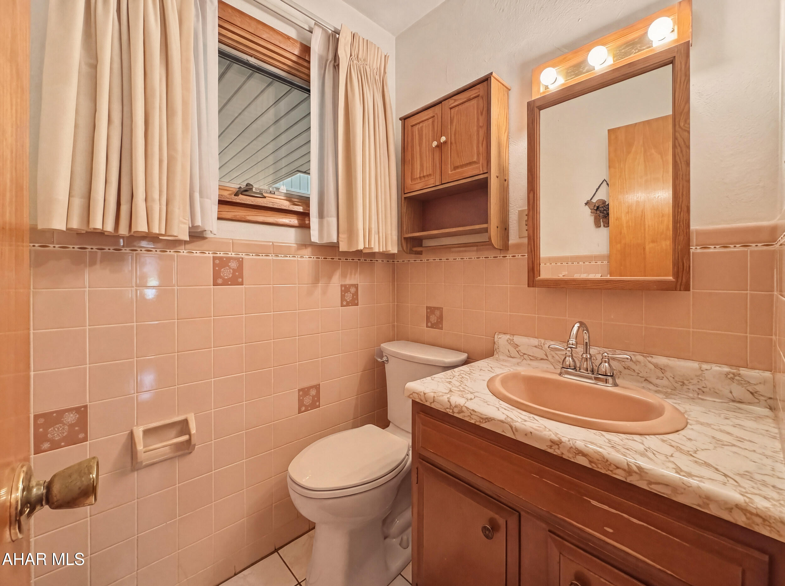 506 Ruby Street Windber, PA 15963 - Photo 19 of 38 a bathroom with a toilet a sink and mirror