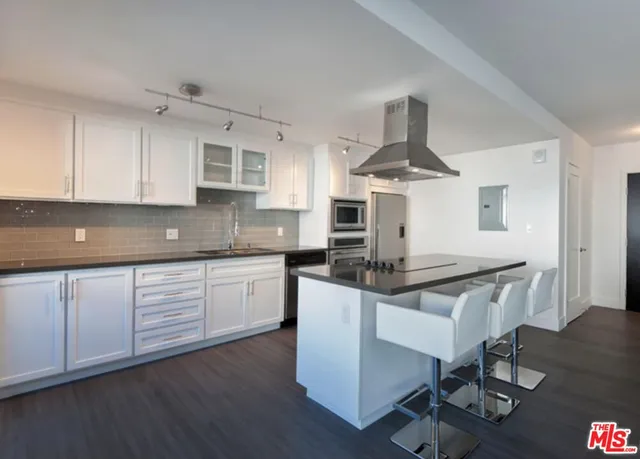 a kitchen with stainless steel appliances a sink and cabinets