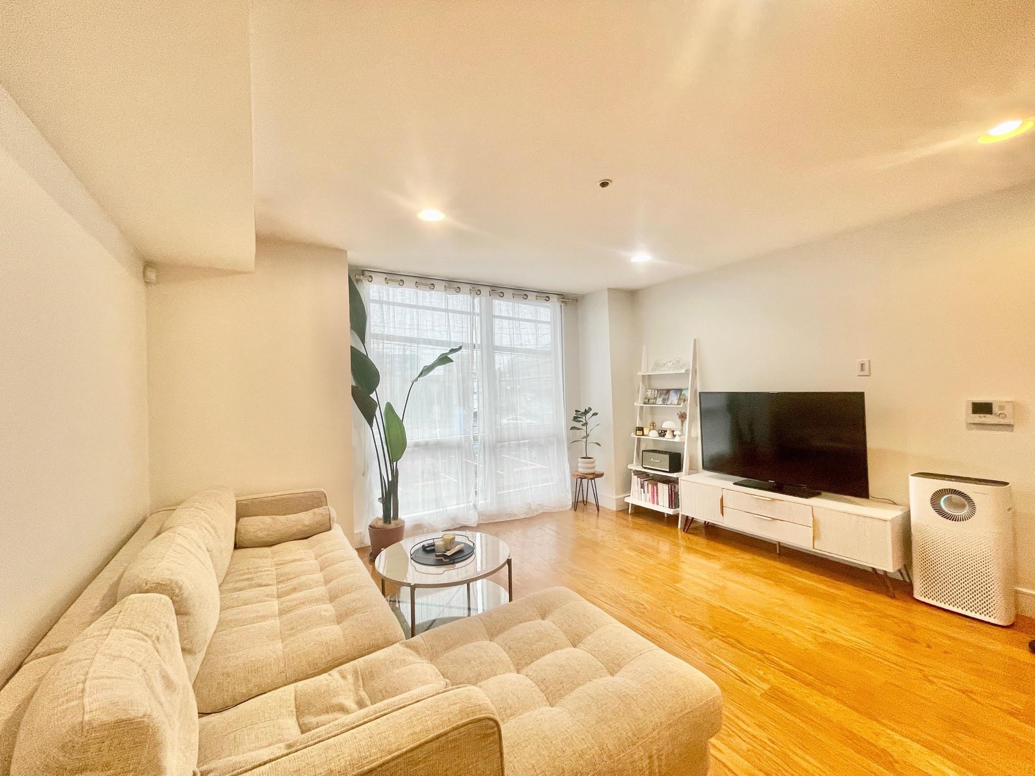 8917 Old River Road, Unit 5 Edgewater, NJ 07047 - Photo 3 of 7 a living room with furniture and a flat screen tv