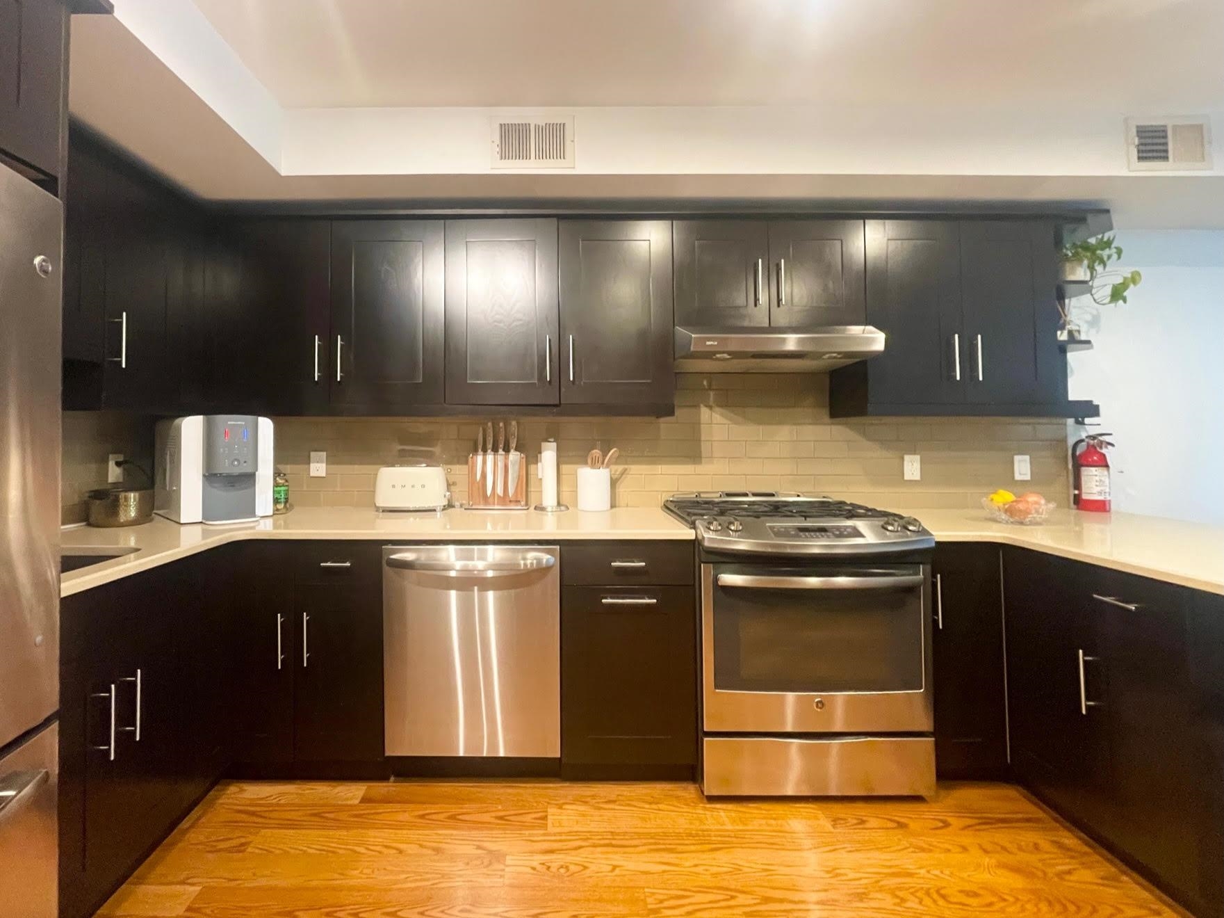 8917 Old River Road, Unit 5 Edgewater, NJ 07047 - Photo 5 of 7 a kitchen with a stove and a sink