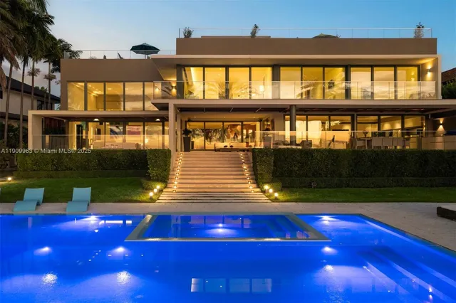 a view of a yard with a floor to ceiling window and potted plants