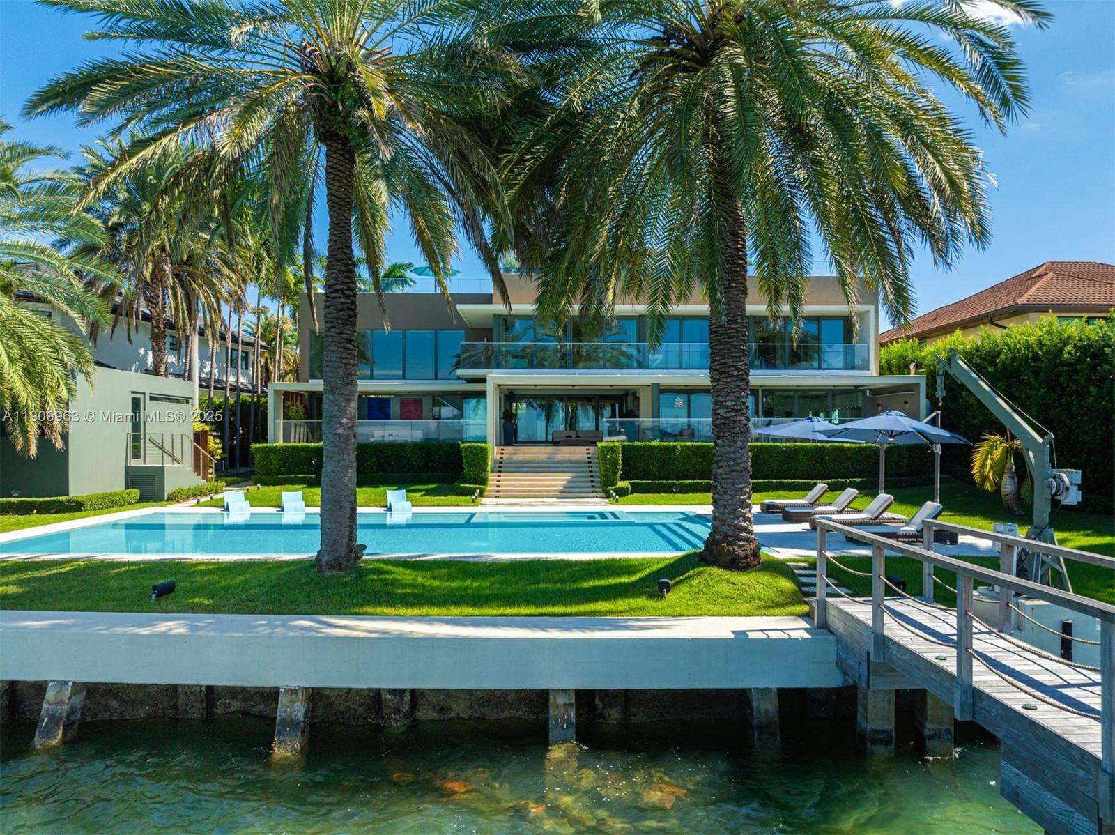 360 Harbor Drive Key Biscayne, FL 33149 - Photo 17 of 86 a view of swimming pool with lawn chairs and a big yard