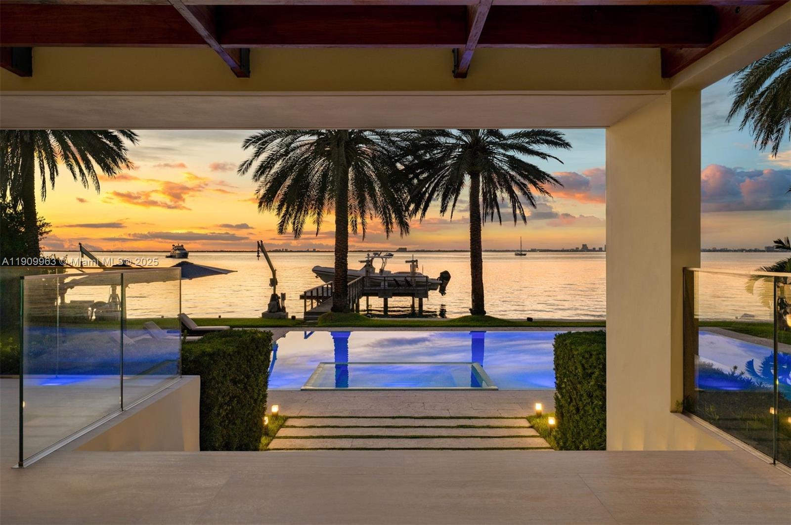 360 Harbor Drive Key Biscayne, FL 33149 - Photo 27 of 86 a view of a yard with a floor to ceiling window and potted plants