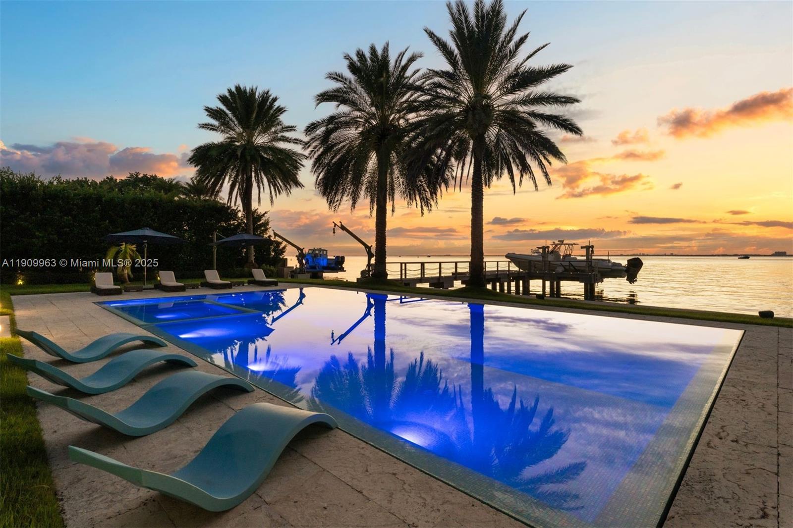 360 Harbor Drive Key Biscayne, FL 33149 - Photo 29 of 86 a view of a swimming pool with a lounge chair and lake view