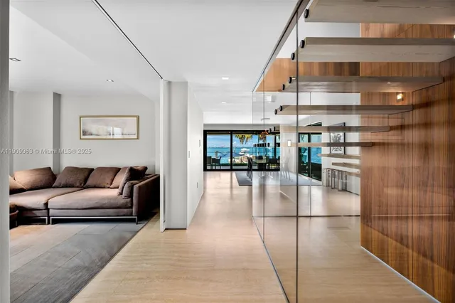 a room with furniture pool table and glass windows