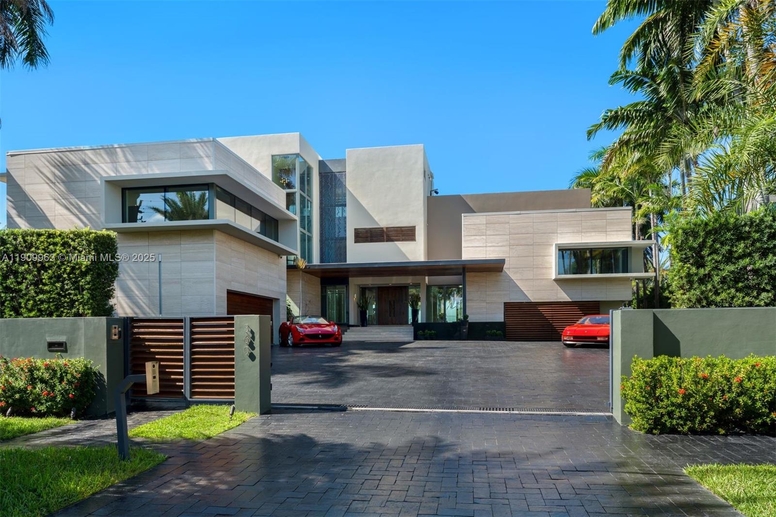 360 Harbor Drive Key Biscayne, FL 33149 - Photo 4 of 86 a front view of a house with a garden