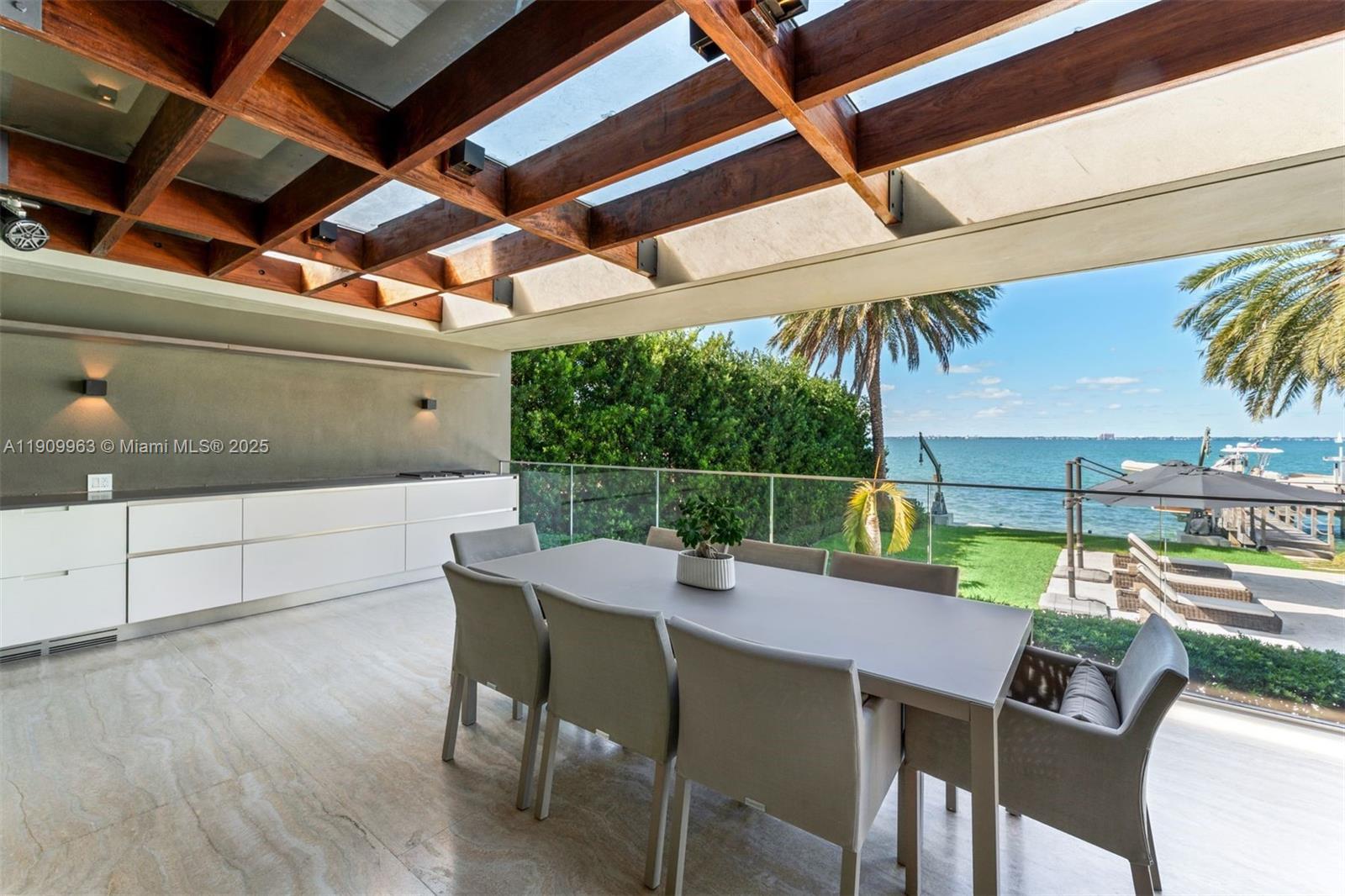 360 Harbor Drive Key Biscayne, FL 33149 - Photo 44 of 86 a view of a dining table and chairs in patio