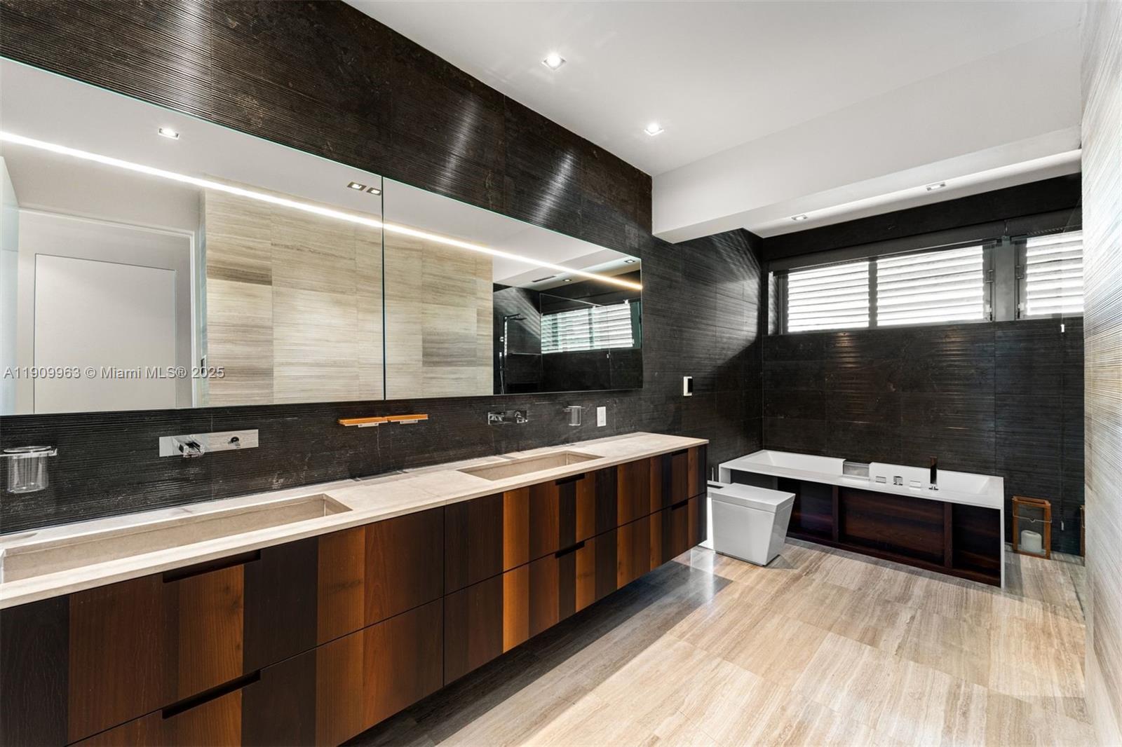 360 Harbor Drive Key Biscayne, FL 33149 - Photo 50 of 86 a bathroom with a sink and a mirror