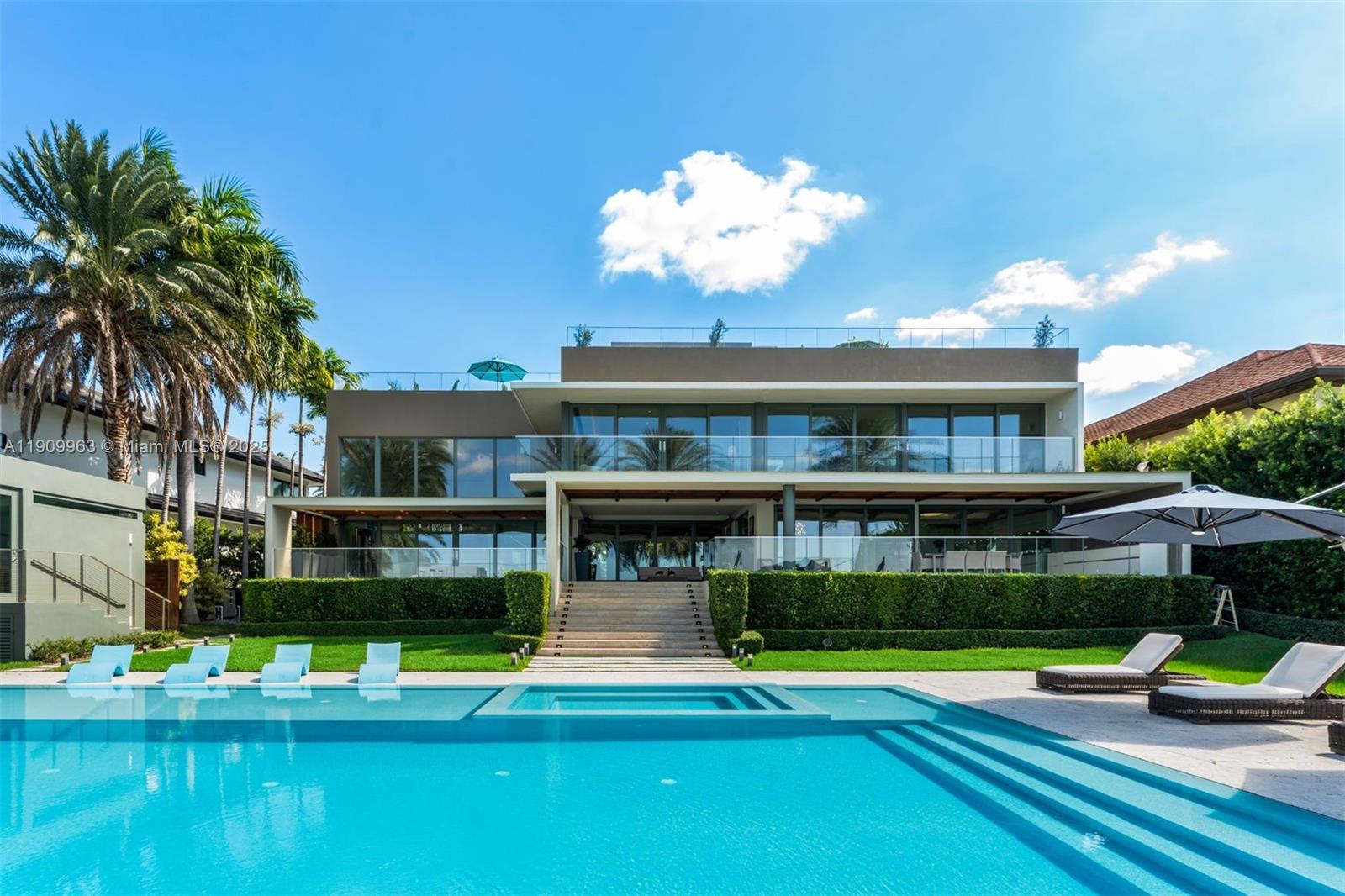 360 Harbor Drive Key Biscayne, FL 33149 - Photo 76 of 86 a view of a swimming pool with lawn chairs and plants