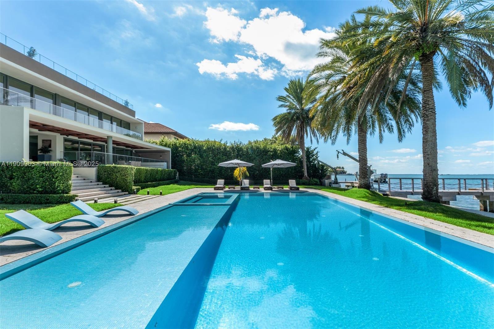 360 Harbor Drive Key Biscayne, FL 33149 - Photo 77 of 86 a view of swimming pool with lawn chairs and a large tree