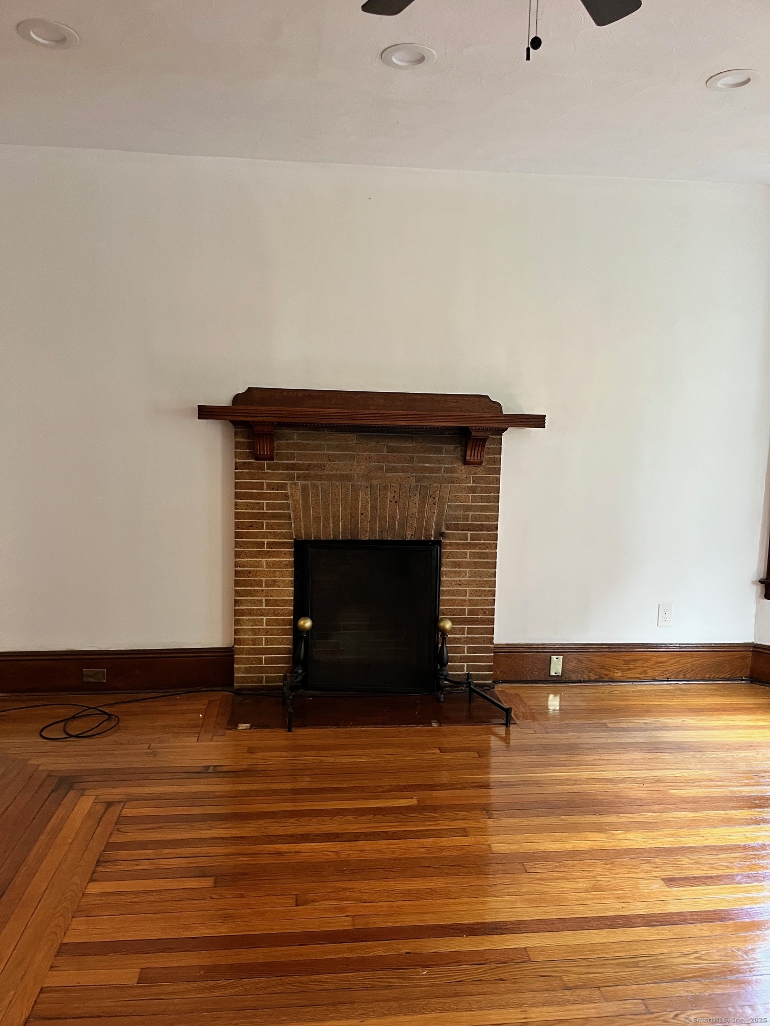 308 Edgewood Street, Unit 1 Hartford, CT 06112 - Photo 13 of 23 a view of a livingroom with wooden floor and a fireplace