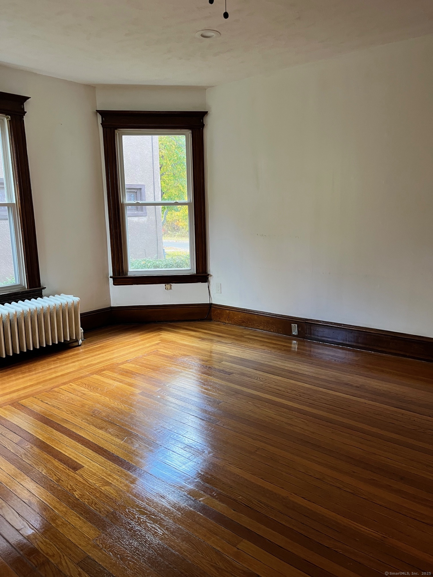 308 Edgewood Street, Unit 1 Hartford, CT 06112 - Photo 14 of 23 a view of an empty room with wooden floor and a window