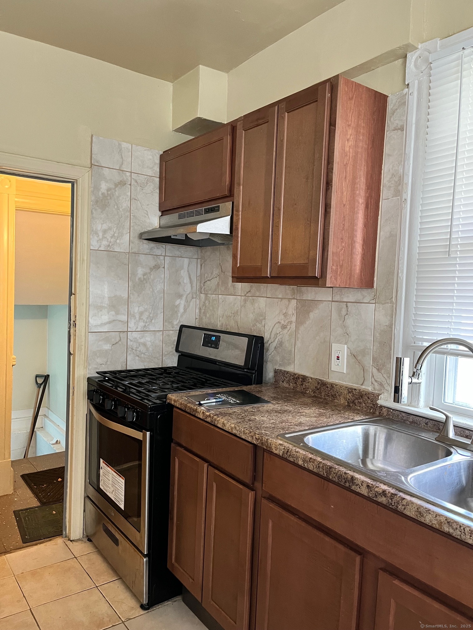 308 Edgewood Street, Unit 1 Hartford, CT 06112 - Photo 8 of 23 a kitchen with granite countertop a sink a stove and cabinets