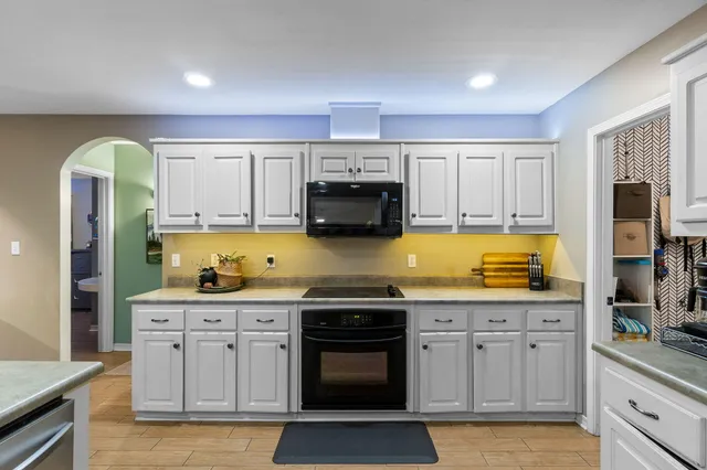 a kitchen with stainless steel appliances granite countertop a stove and a sink