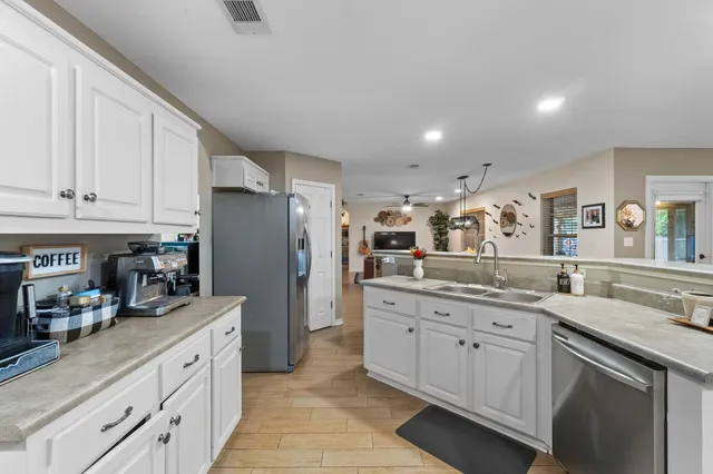 a kitchen with granite countertop cabinets stainless steel appliances a sink and a counter top space