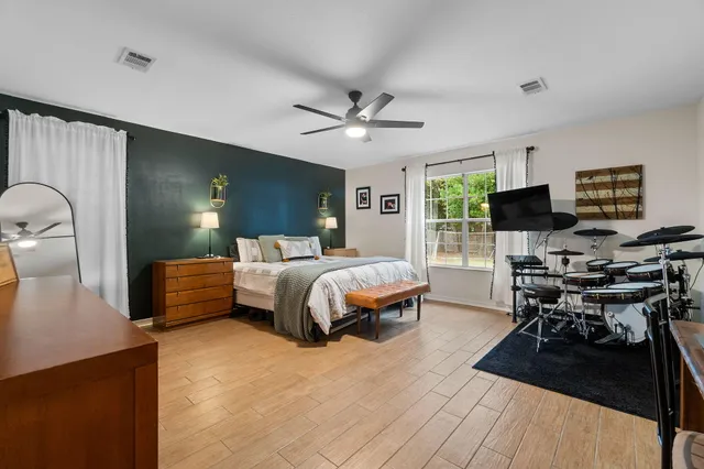 a bedroom with a bed and wooden floor