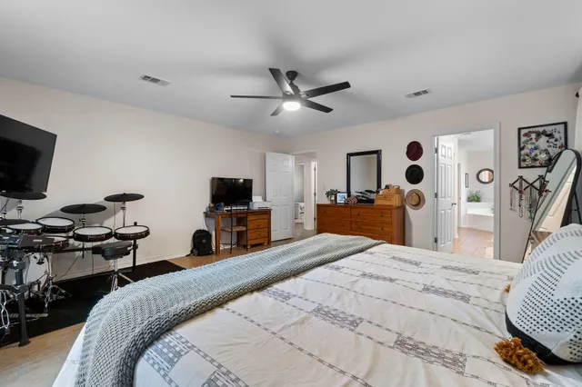 a bedroom with a bed and a flat screen tv