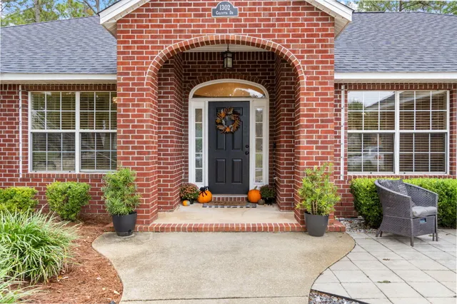a front view of a house with potted plants