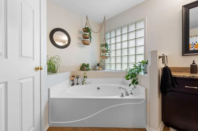 a bathroom with a tub and sink