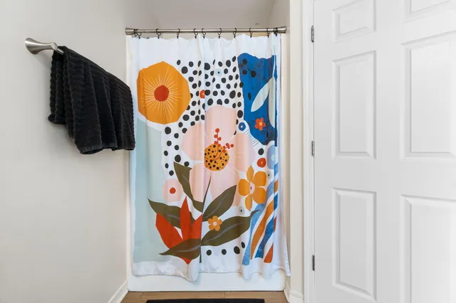 a view of a patio with couches chairs and a large tree