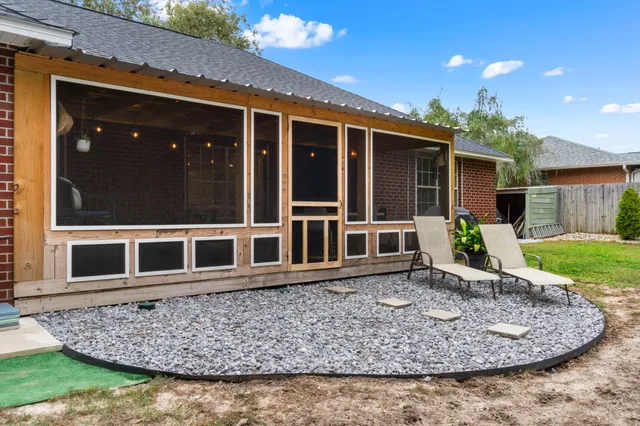 a view of a backyard with chairs
