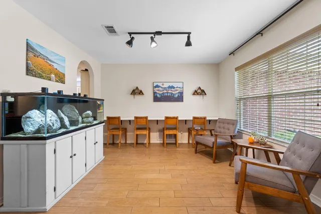 a room with furniture pool table and window