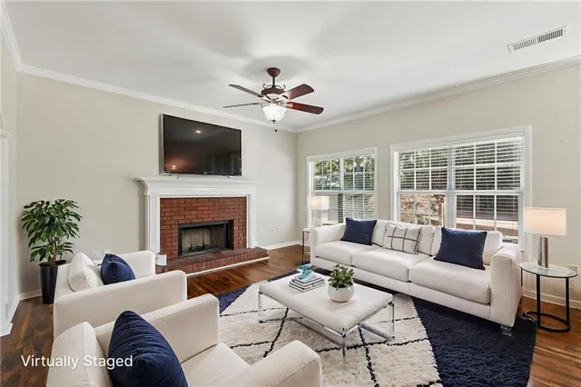 a living room with furniture a flat screen tv and a fireplace