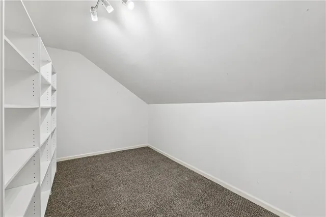 a bedroom with a bed a couch and a window