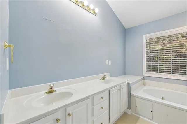 a view of a house with a wooden deck and furniture
