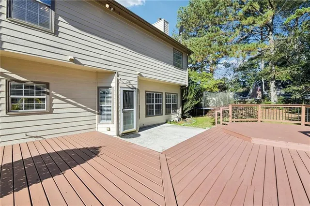 an aerial view of a house with swimming pool and garden