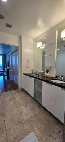 a large bathroom with a sink and mirror