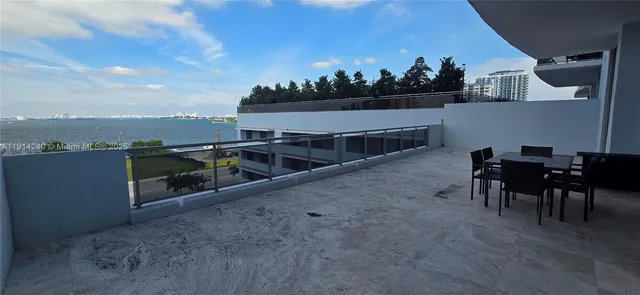 a view of a terrace with furniture and a potted plant