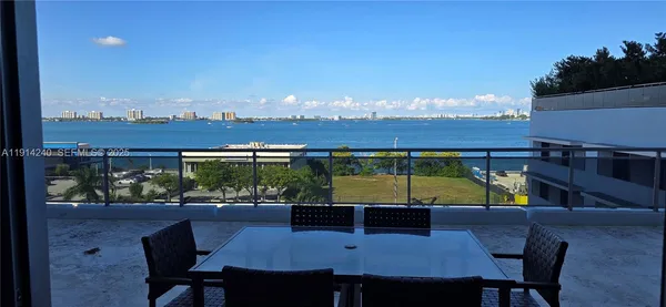 a view of a patio with table and chairs