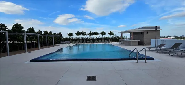 a view of a swimming pool with lounge chair