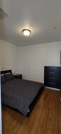 a bedroom with a bed and a cabinet