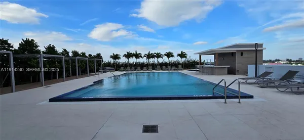 a view of a swimming pool with lounge chair