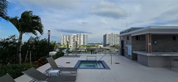 a living room with patio furniture and a potted plant