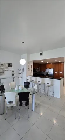 a living room with furniture and a kitchen