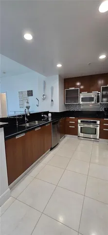 a kitchen with granite countertop a sink and cabinets