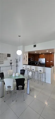 a living room with furniture and a kitchen