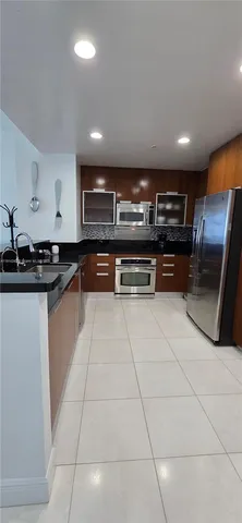 a kitchen with stainless steel appliances granite countertop a sink and cabinets