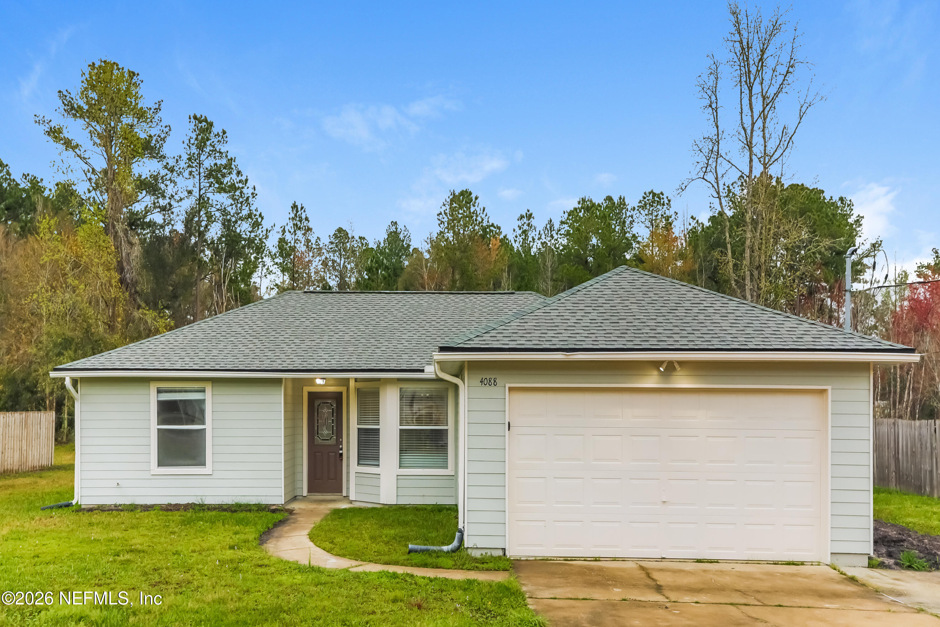 4088 Everett Avenue Middleburg, FL 32068 - Photo 1 of 16 a front view of a house with garden