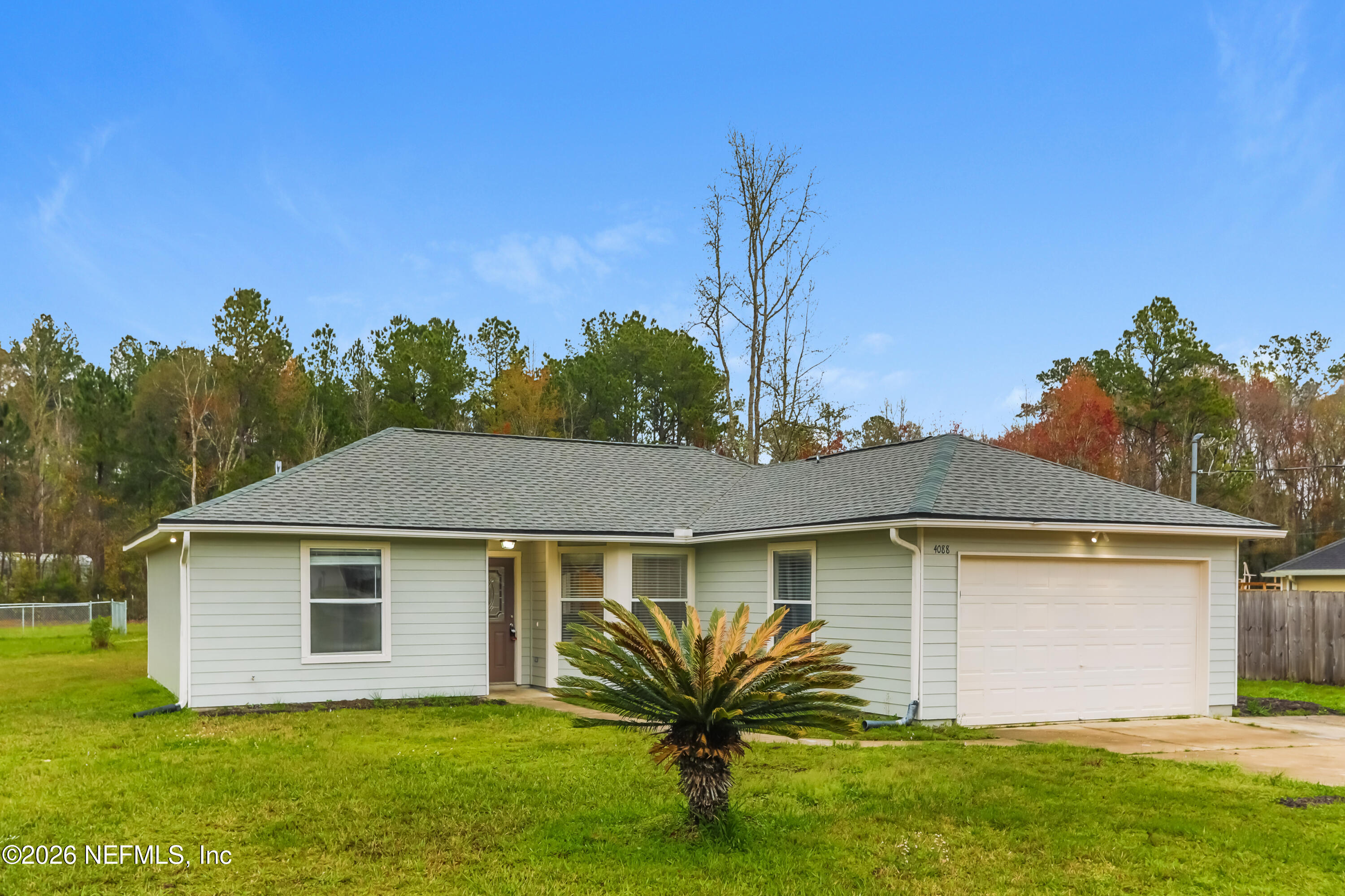 4088 Everett Avenue Middleburg, FL 32068 - Photo 3 of 16 a front view of house with yard and trees in the background