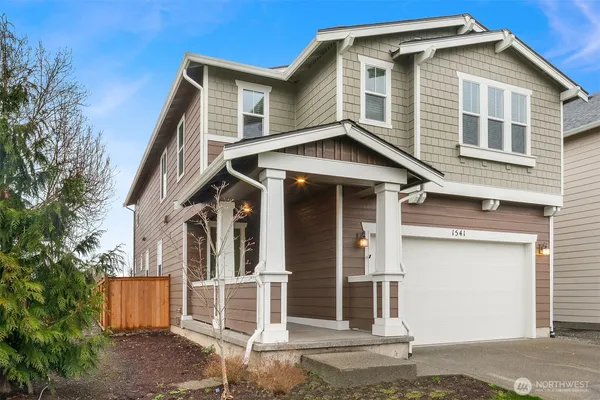 a front view of a house with a garage