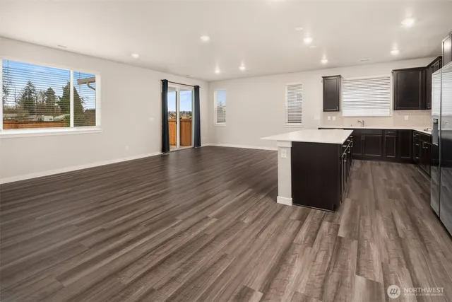 a view of kitchen with wooden floor and electronic appliances