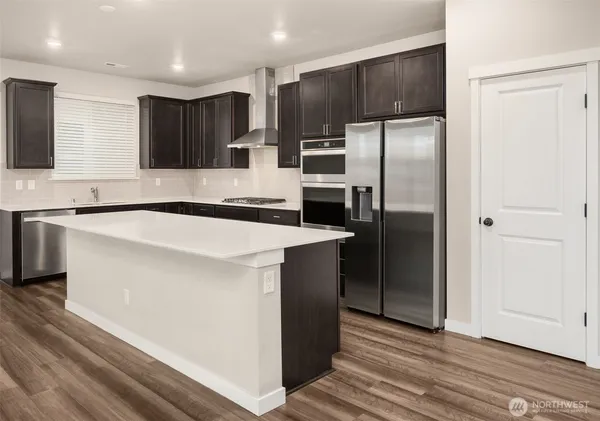 a kitchen with stainless steel appliances a refrigerator and a sink